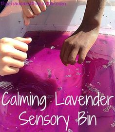 a child's hand reaching for something in a pink container with the words, calming lavender sensory bin