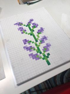 a piece of paper that has been made to look like a cross stitched flower