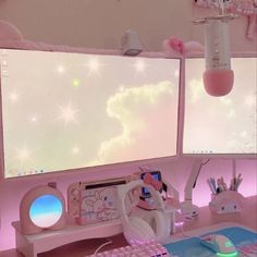 two computer monitors sitting on top of a desk next to a keyboard and mouse pad