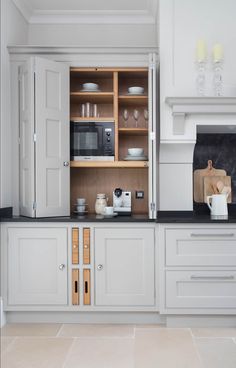 a kitchen with white cabinets and black counter tops