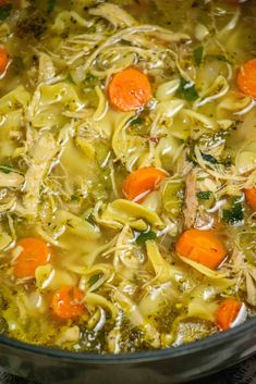 chicken noodle soup with carrots and broccoli in a pot