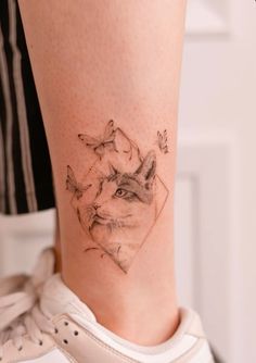 a woman's leg with a tattoo on it that has an image of a fox