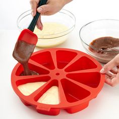 a person using a spatula to mix ingredients in a bowl