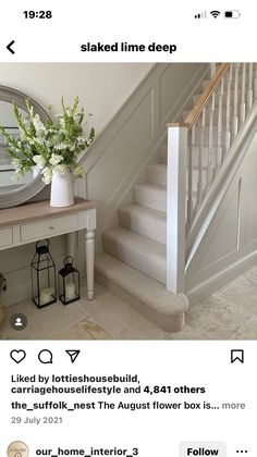 the stairs in this house are painted white and have flowers on each step, along with an oval mirror above them