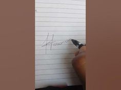 a person writing on a piece of paper with a pen in their left hand and an arrow drawn on it