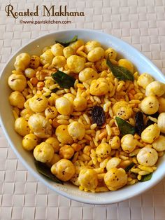 a white bowl filled with corn on top of a table