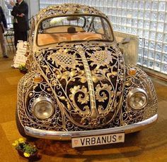 an antique vw bug is on display in a museum