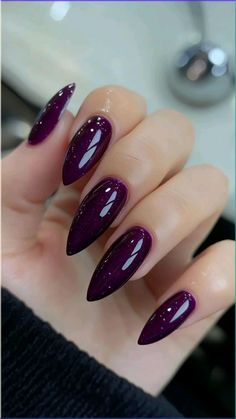 These glossy, juicy purple nails give off the most elegant and deep fall vibe. 💜💅  Items you could buy to achieve this look are included under the pin description, if you need.   I earn commissions on affiliate links. Fall Nails Deep Purple, Plum Nails Design, Plum Nails With Design Fall, Plum Almond Nails, Purple Brown Nails, Plum Color Nails, Deep Plum Nails, Plum Colored Nails, Dark Purple Fall Nails