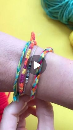 someone is holding onto their colorful bracelets