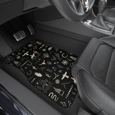 the interior of a car is decorated with black and white symbols, such as stars, moon, saturn, and other things