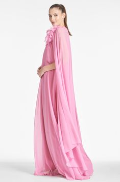 Pink Spring Evening Gown, Pink Evening Gown For Spring, Pink Georgette Dresses For Wedding Guests, Pink Flowy Gown For Party, Flowy Maxi Dress With Cape Sleeves For Spring, Pink Chiffon Maxi Dress For Wedding, Flowy Pink Maxi Dress For Evening, Spring Wedding Guest Dress With Cape Sleeves, Feminine Pink Gown For Wedding Guest