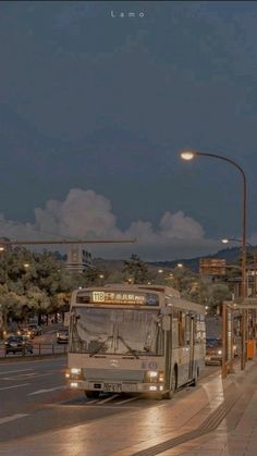 a bus is driving down the street at night