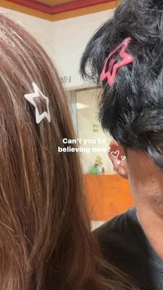 two people with hair clips on their ears