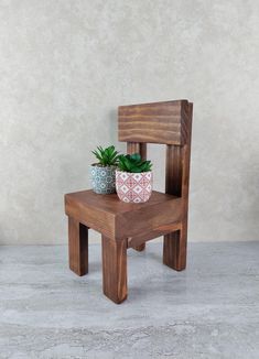 a small wooden chair with a potted plant on it