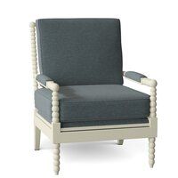 the arm chair is made from wood and has grey fabric with white trimmings