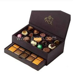 an open chocolate box filled with different types of candies