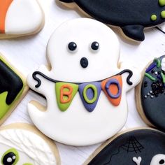 decorated cookies are arranged in the shape of ghostes