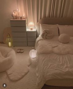 a bed with white sheets and pillows on top of it next to a night stand