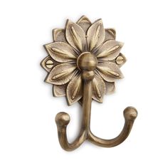 an antique style hook with a flower on it