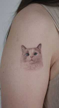 a woman with a cat tattoo on her shoulder