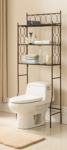 a white toilet sitting next to a metal shelf filled with towels and other items on top of it