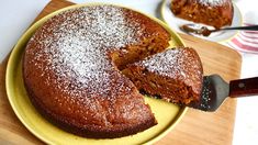 a cake on a yellow plate with a knife in it and another piece missing from the cake