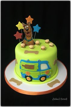 a birthday cake with a dog on top and stars in the sky, is decorated to look like a bus