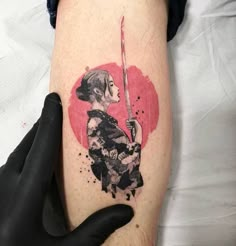 a person with a tattoo on their arm holding a knife in front of a heart