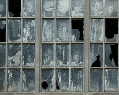 an old window with broken glass on it