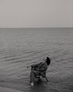 a person sitting on a chair in the water