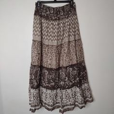 Embrace Your Free Spirit With This Stunning Bohemian Maxi Skirt, Featuring A Rich, Earthy Color Palette In Shades Of Brown And Cream. This Skirt Showcases A Beautifully Intricate Print With A Blend Of Patterns, Offering An Effortless Yet Stylish Look. Perfect For Any Casual Or Festive Occasion, It Provides Comfort And Versatility. The Flowing Fabric Ensures Ease Of Movement, Making It Ideal For Warm Days And Outdoor Events. Pair It With A Simple Top And Sandals For A Complete Boho-Chic Outfit. Paisley Maxi Skirt, Outdoor Outfits, Bohemian Maxi Skirt, Mid Length Skirt, Flowing Fabric, Bohemian Maxi, Earthy Color Palette, Brown Skirt, Simple Top