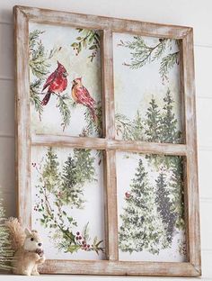 an old window is decorated with birds and evergreens on the wall next to a teddy bear