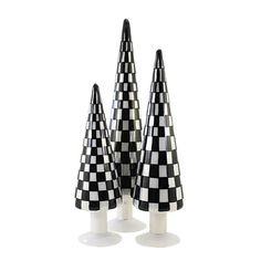 three black and white checkered cone shaped candles