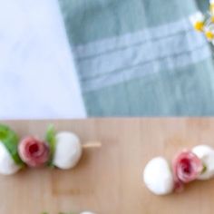 small appetizers are arranged on a cutting board and ready to be eaten by someone