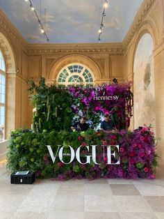 an indoor display with flowers and greenery