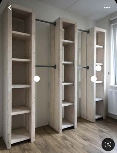 an empty room with wooden shelves and lights