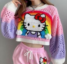 a girl in pink shorts and a hello kitty cropped sweater is posing for the camera