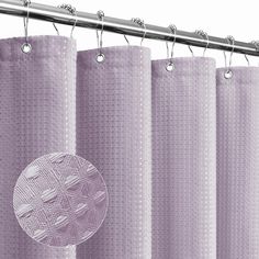 a shower curtain with a circular design on the top and bottom, hanging from a metal rod