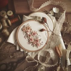 a table topped with lots of different types of embroidery