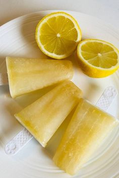 three slices of lemon sitting on top of a white plate