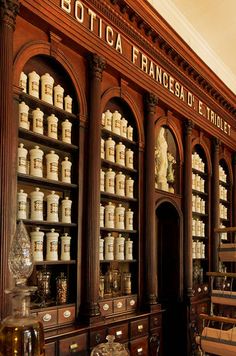 an old fashioned pharmacy cabinet filled with lots of bottles