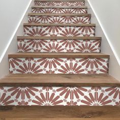 the stairs are decorated with red and white wallpaper