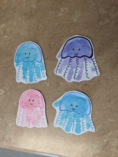 three jellyfish stickers sitting on top of a counter