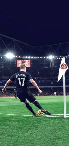 a soccer player dives for the ball during a game