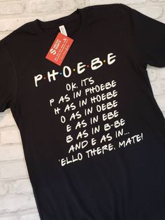 Phoebe Name Spelling Friends Heather Grey Cotton Comfy T-Shirt The colored heather t-shirts give your shirt a little more texture and dimension than a solid color shirt. Phoebe Ok, it's P as in "Phoebe" H as in "hebe" O as in "oebe" E as in "ebe" B as in "b-be" and E as in "ello there, mate!" Funny friends TV show quotes **************************************************************************************** T-Shirt Color Options: Black, White, Grey, Raspberry, Navy, Maroon, Deep Teal Unisex Siz Phoebe Name, Friends Tv Show Shirts, I Wish I Could But I Don't Want To Phoebe, Friends Shirt Ideas Tv Show, Friends Shirts Tv Show, Friends Tv Tshirt, Know It’s For The Better Phoebe, Friends Tv Show Shirt, Shirts Diy