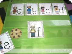 a green table topped with lots of cards next to cookies and cookies on top of it