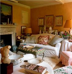 a living room filled with lots of furniture next to a fire place in a fireplace