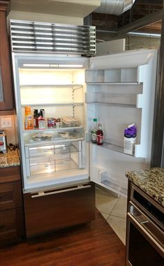 an open refrigerator with the door wide open