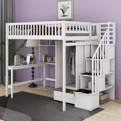 a loft bed with stairs and desk underneath it in a purple walled living room area