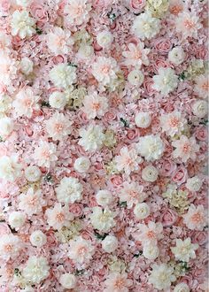 a wall covered in lots of pink and white flowers